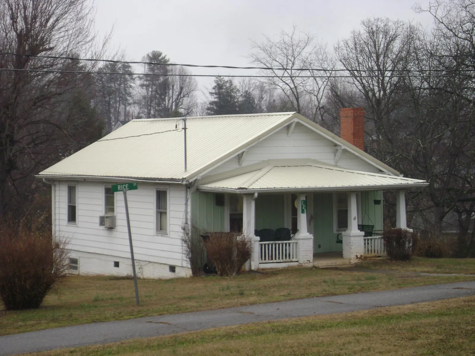White metal roof on a craftsman bungalow at a street corner in Pinehurst